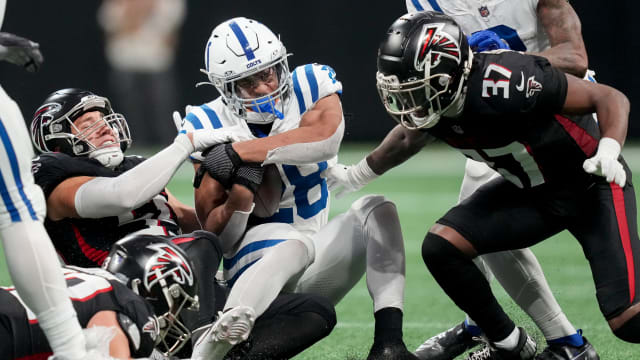 Indianapolis Colts running back Jonathan Taylor (28) is brought down by Atlanta Falcons defenders during a game against at Mercedes-Benz Stadium.